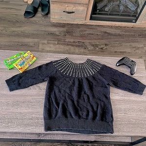 Sweater that is black but has silver details neck line.